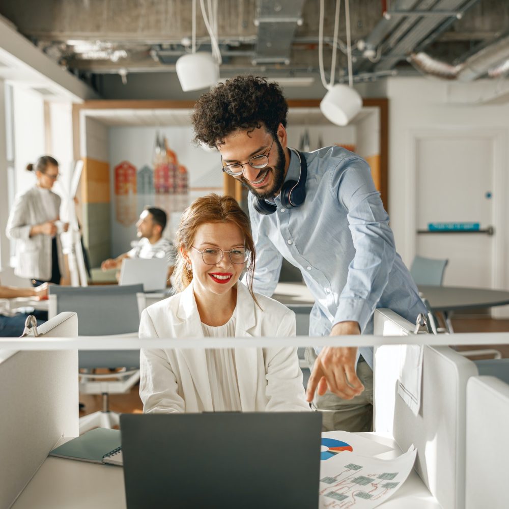 businesspeople-working-together-in-bright-office-sitting-at-desk.jpg